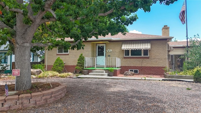 4420 Teller St, Wheat Ridge, CO 80033 - view of front of house with a chimney, brick siding, crawl space, and roof with shingles