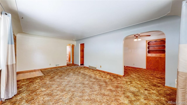 4420 Teller St, Wheat Ridge, CO 80033 - spare room featuring arched walkways, carpet flooring, and a ceiling fan