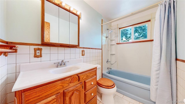 4420 Teller St, Wheat Ridge, CO 80033 - bathroom with tile walls, shower / bath combo with shower curtain, vanity, and tile patterned floors