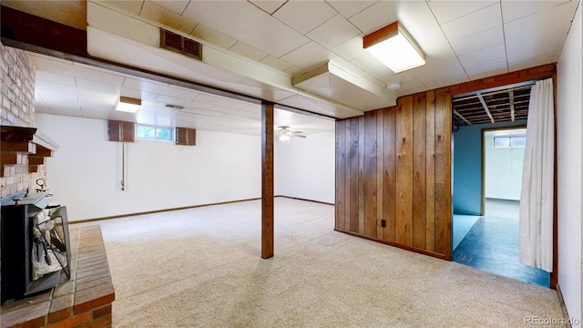 4420 Teller St, Wheat Ridge, CO 80033 - basement with healthy amount of natural light, carpet flooring, and wooden walls