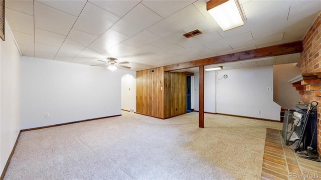 4420 Teller St, Wheat Ridge, CO 80033 - basement with carpet, ceiling fan, a fireplace, wooden walls, and arched walkways