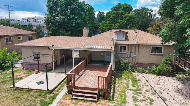 4420 Teller St, Wheat Ridge, CO 80033 - back of property featuring a wooden deck, a chimney, a shingled roof, and brick siding
