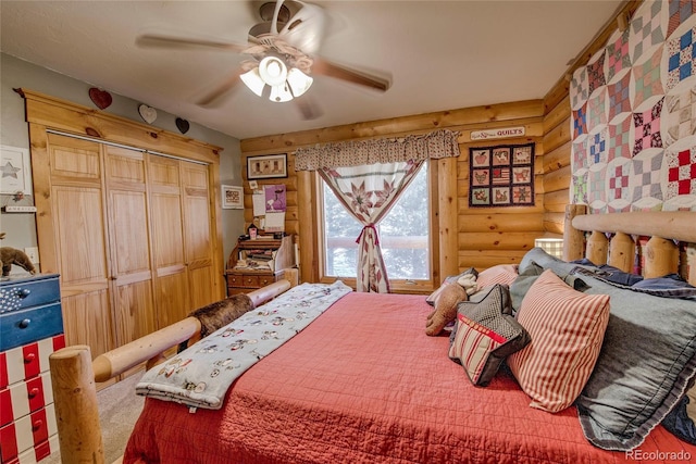 bedroom featuring a closet, rustic walls, and ceiling fan