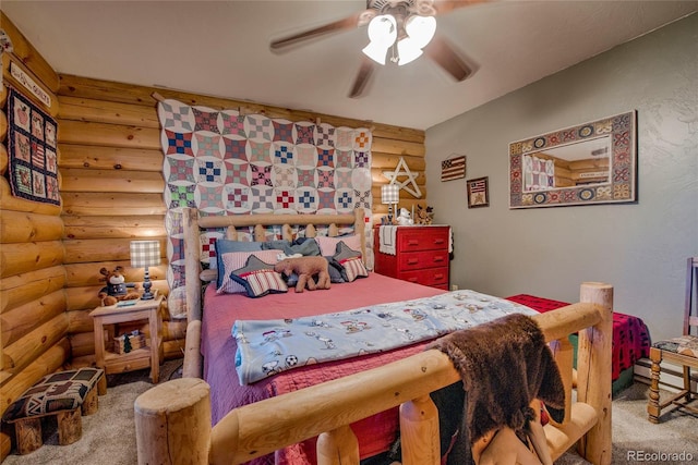 bedroom with rustic walls, ceiling fan, and carpet floors