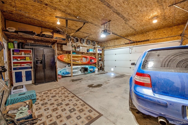 garage with black fridge with ice dispenser and a garage door opener