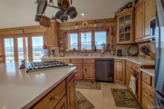 kitchen featuring light tile patterned flooring, sink, appliances with stainless steel finishes, and tasteful backsplash