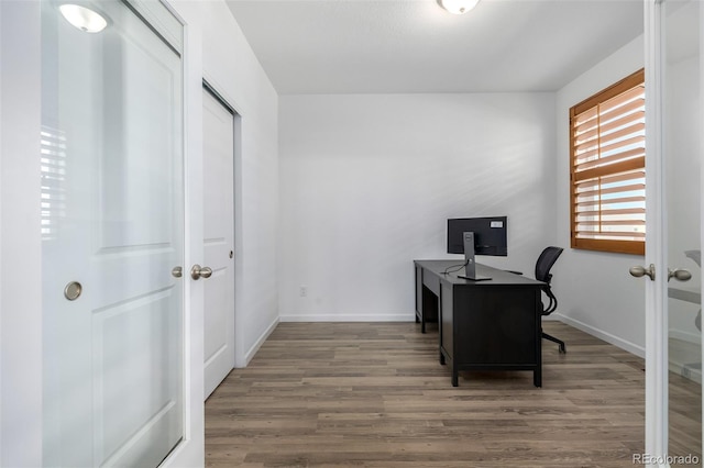 office with wood finished floors and baseboards