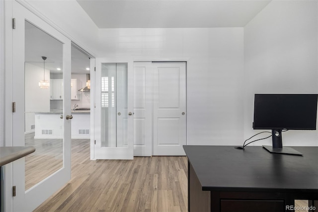 office with visible vents and light wood-style floors