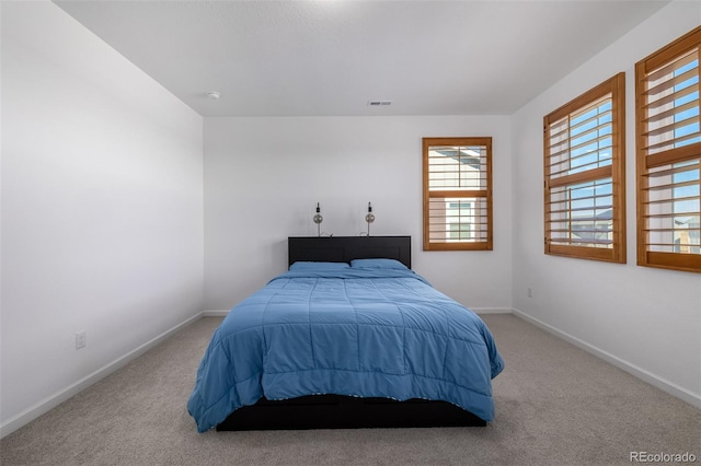 bedroom featuring visible vents, carpet floors, and baseboards