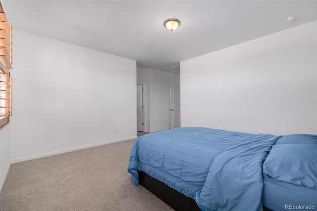 bedroom featuring baseboards and carpet floors