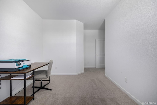 carpeted office featuring baseboards