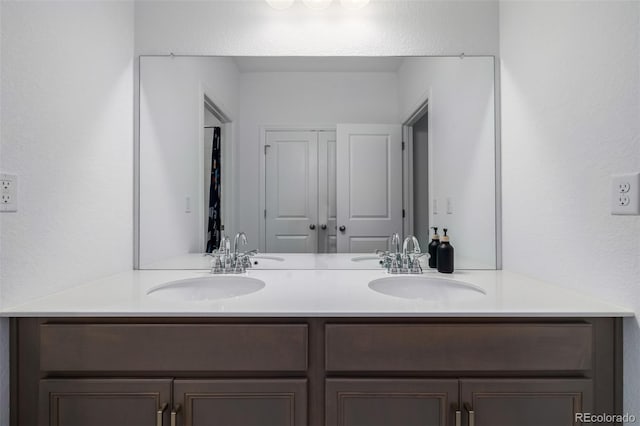 full bath with double vanity and a sink