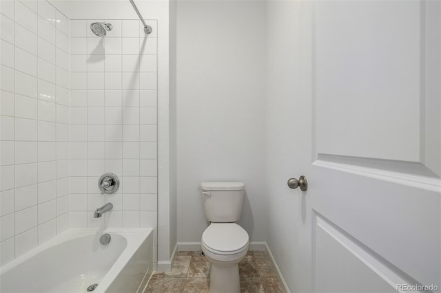 full bath featuring tub / shower combination, toilet, and baseboards