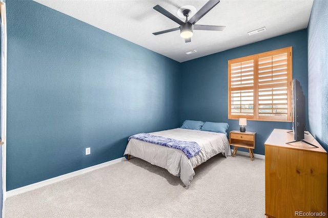 carpeted bedroom with visible vents, a ceiling fan, and baseboards