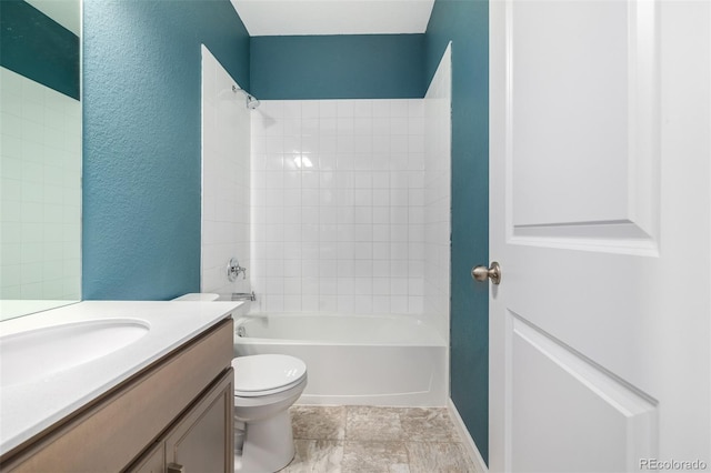 full bath featuring tub / shower combination, toilet, vanity, and a textured wall