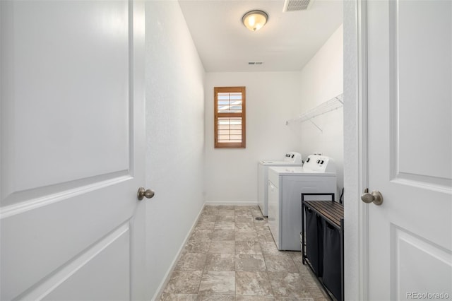 laundry area featuring laundry area, washer and dryer, visible vents, and baseboards