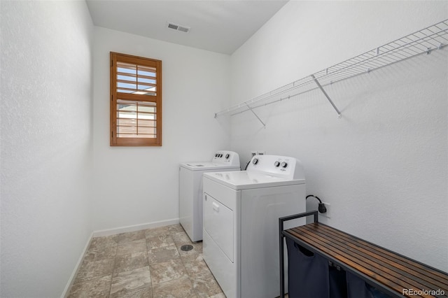 laundry room featuring visible vents, baseboards, independent washer and dryer, and laundry area