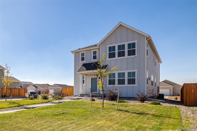 view of front facade with board and batten siding, central AC, a front lawn, and fence