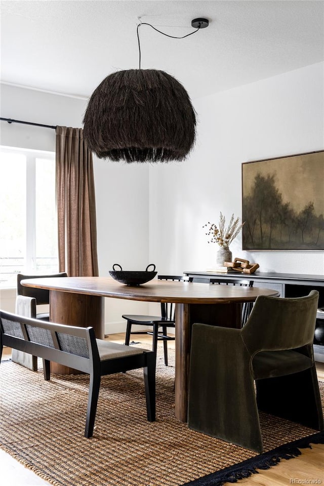 dining space featuring light wood finished floors