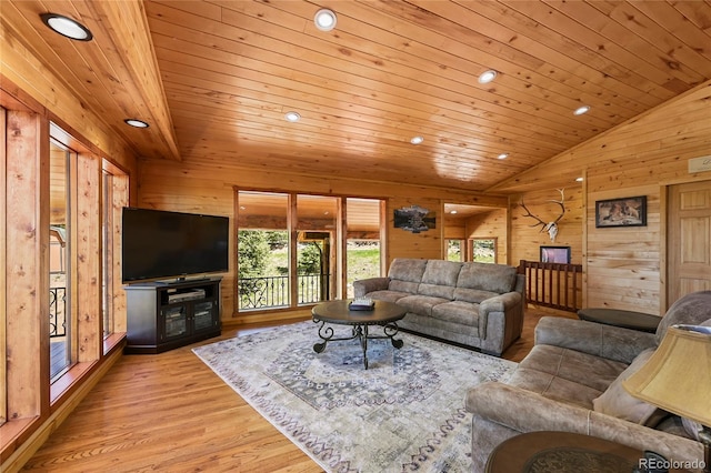 living area featuring lofted ceiling, wood ceiling, and wooden walls