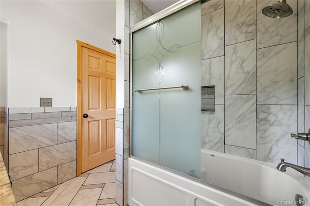 bathroom with tile walls and shower / tub combination