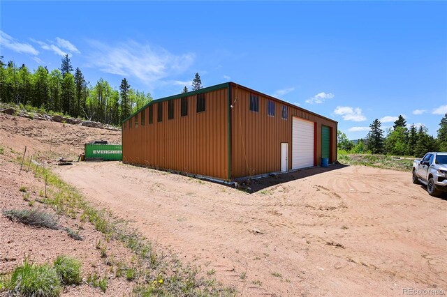 view of outbuilding with an outdoor structure and dirt driveway