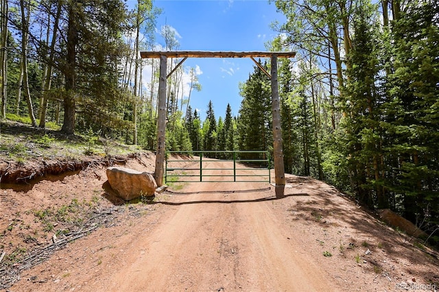 view of road featuring a gate and a gated entry