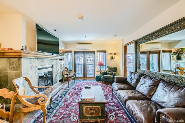 living room with a wall mounted air conditioner, a fireplace, and french doors