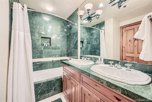 bathroom featuring vanity and shower / bathtub combination with curtain