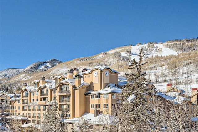 snow covered building with a mountain view