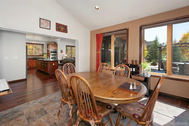 27 Habitat, Dillon, CO 80435 - dining space featuring dark wood-type flooring, high vaulted ceiling, and recessed lighting