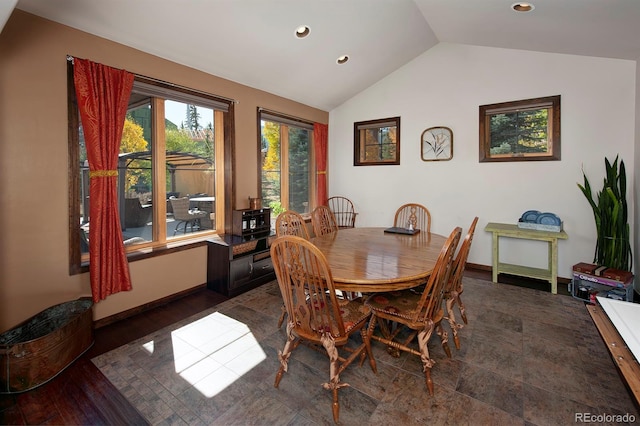 dining area with vaulted ceiling and dark wood-type flooring