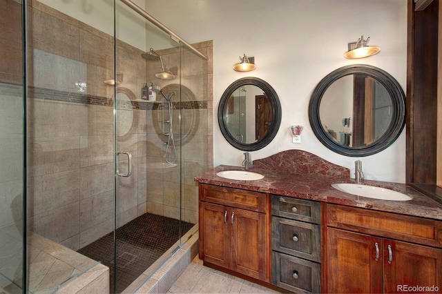 bathroom featuring tile patterned flooring, vanity, and walk in shower