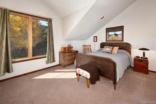 carpeted bedroom with lofted ceiling