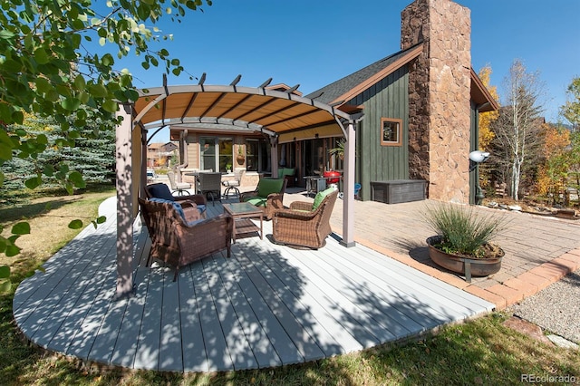 exterior space featuring a pergola, an outdoor hangout area, and a deck