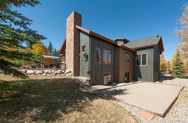 27 Habitat, Dillon, CO 80435 - rear view of house featuring a patio area and a chimney