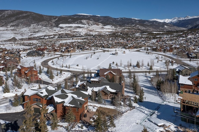 snowy aerial view featuring a mountain view