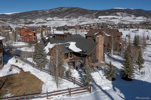 snowy aerial view featuring a mountain view