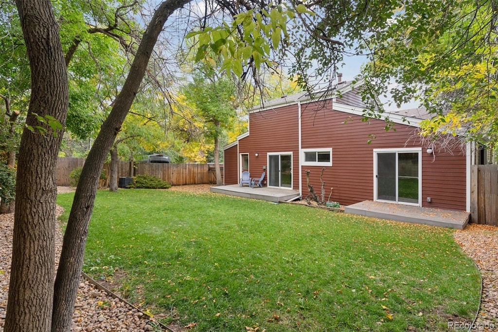 back of property featuring a yard and a patio