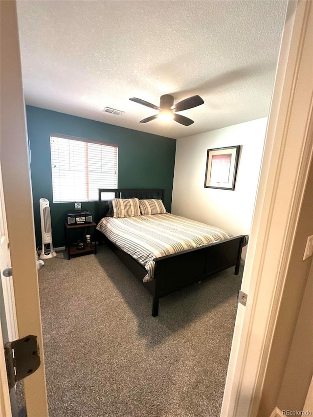 11975 Riverstone Cir Unit 9C, Commerce City, CO 80640 - carpeted bedroom featuring a textured ceiling and ceiling fan