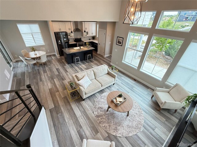 1732 Stable View Dr, Castle Pines, CO 80108 - living room featuring baseboards, a high ceiling, and light wood-type flooring