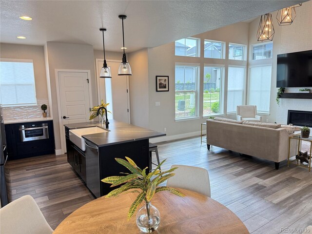 1732 Stable View Dr, Castle Pines, CO 80108 - living area featuring healthy amount of natural light, wood finished floors, a fireplace, and recessed lighting