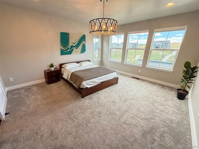 1732 Stable View Dr, Castle Pines, CO 80108 - bedroom with baseboards, carpet, and a chandelier
