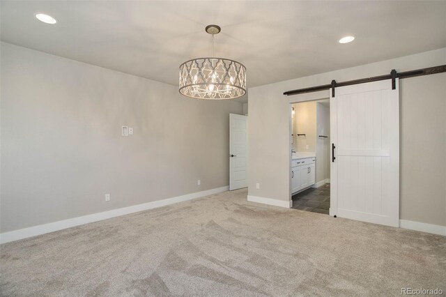 1732 Stable View Dr, Castle Pines, CO 80108 - unfurnished bedroom featuring a barn door, carpet flooring, a chandelier, baseboards, and recessed lighting