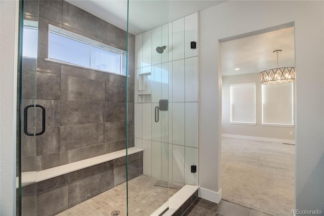 1732 Stable View Dr, Castle Pines, CO 80108 - bathroom featuring a shower stall, tile patterned floors, a chandelier, and baseboards