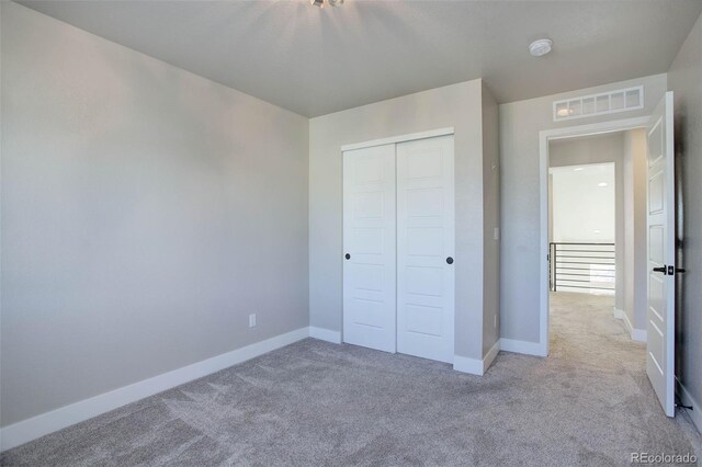 1732 Stable View Dr, Castle Pines, CO 80108 - unfurnished bedroom with light carpet, a closet, and baseboards