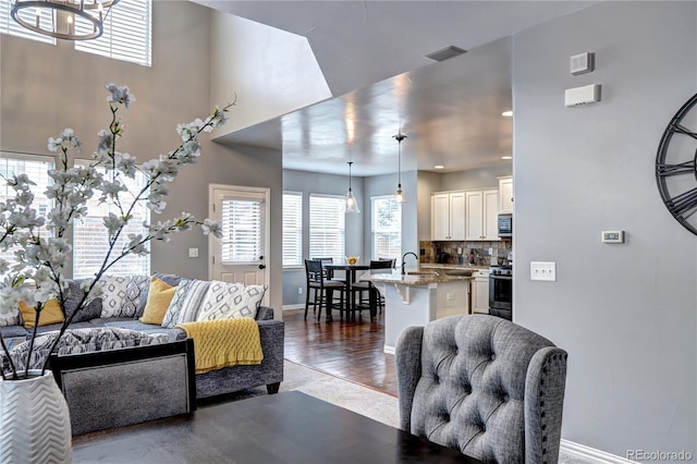 living room featuring sink and hardwood / wood-style floors