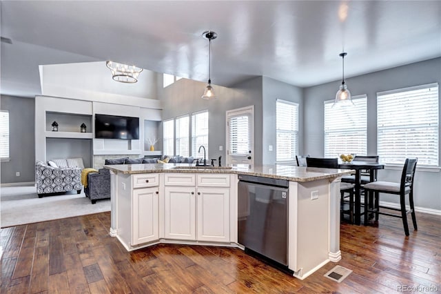 kitchen featuring sink, pendant lighting, an island with sink, and dishwasher