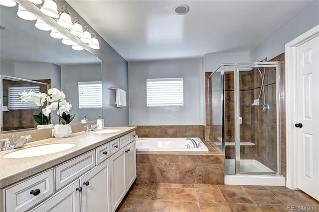 bathroom featuring shower with separate bathtub, tile patterned floors, and vanity