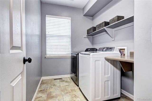 washroom with independent washer and dryer